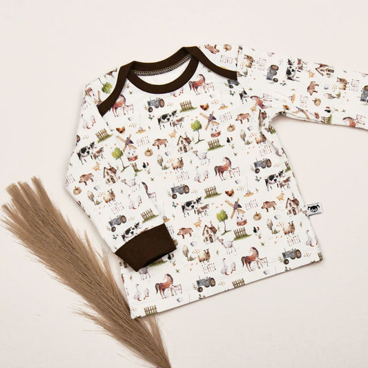 Langärmeliges Babyshirt ‚Bauernhof‘ aus Jersey mit Tiermotiv und braunen Bündchen, amerikanischer Ausschnitt
